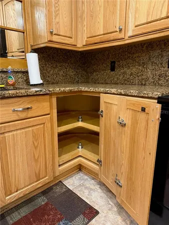 a view of empty room with fireplace and chandelier