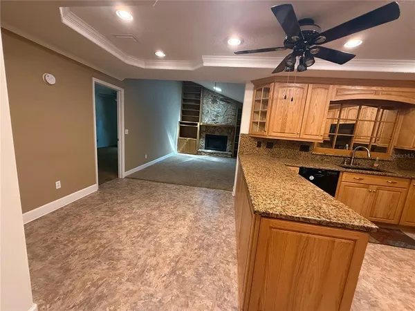 a view of empty room with fireplace and window