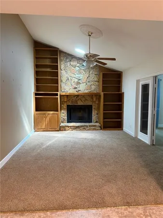 a view of empty room with ceiling fan and window