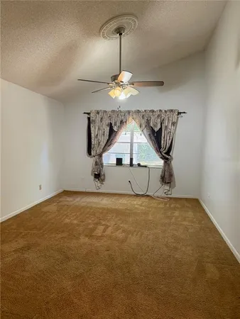 a large kitchen with a large counter top space a sink and stainless steel appliances