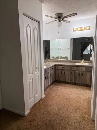 a bathroom with a double vanity sink a mirror and a bathtub
