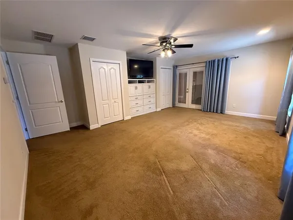a bedroom with a bed and chair