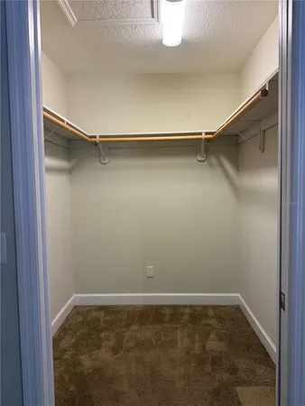 en empty room with windows and ceiling fan