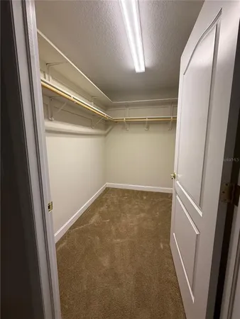 a view of an empty room with a ceiling fan