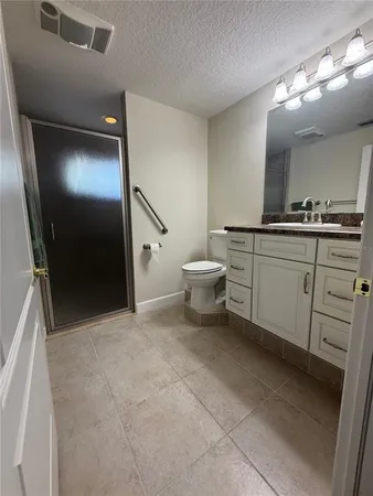 an empty room with windows and ceiling fan