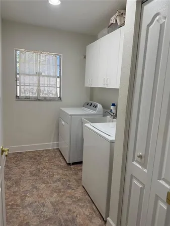 a view of a yard with plants and trees