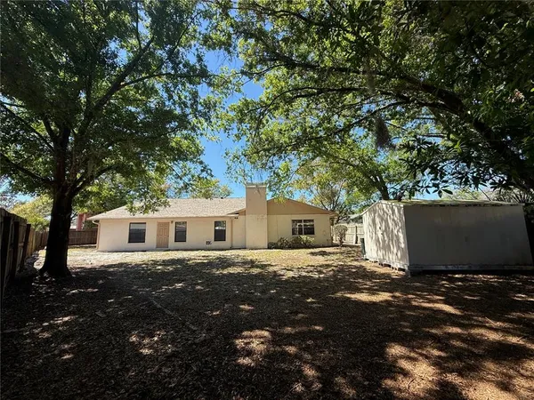 a house that has a tree in front of it