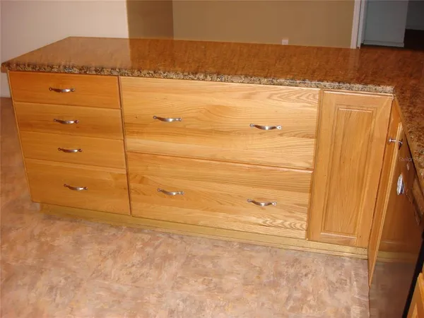a kitchen with granite countertop cabinets and window