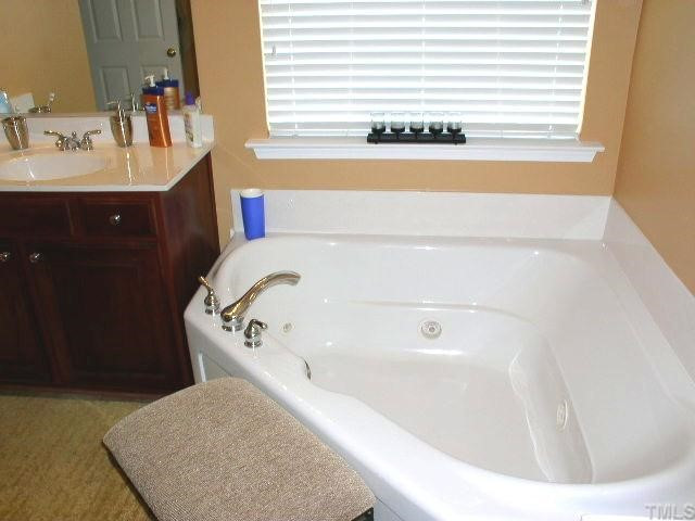 Master Bath has corner jetted tub that separate the two vanities.