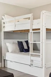 a bedroom with a bed and white cabinets
