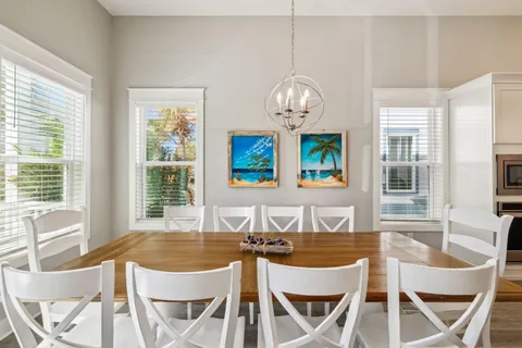 a view of a dining room with furniture wooden floor and chandelier