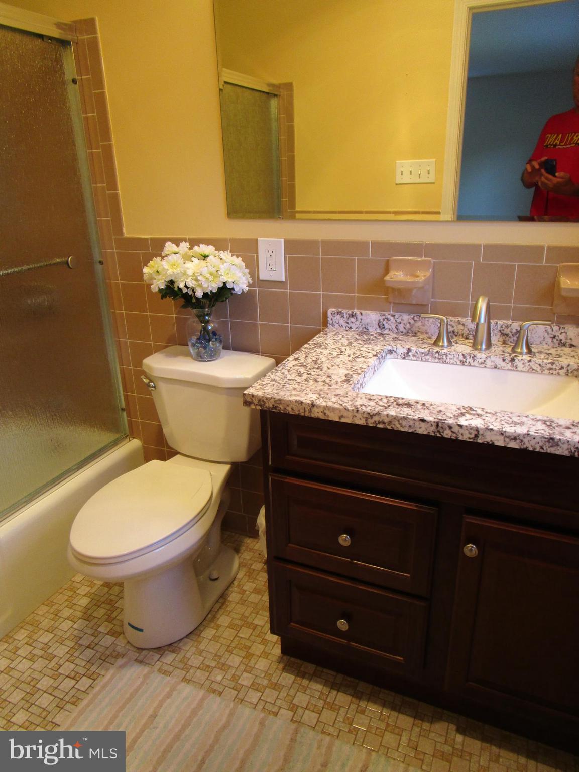 8505 Edenton Road Fulton, MD 20759 - Photo 30 of 38 a bathroom with a granite countertop toilet and a sink