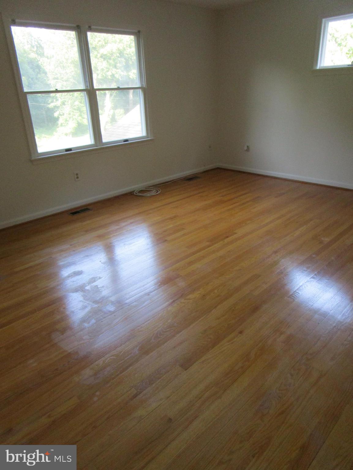 8505 Edenton Road Fulton, MD 20759 - Photo 31 of 38 an empty room with wooden floor and windows