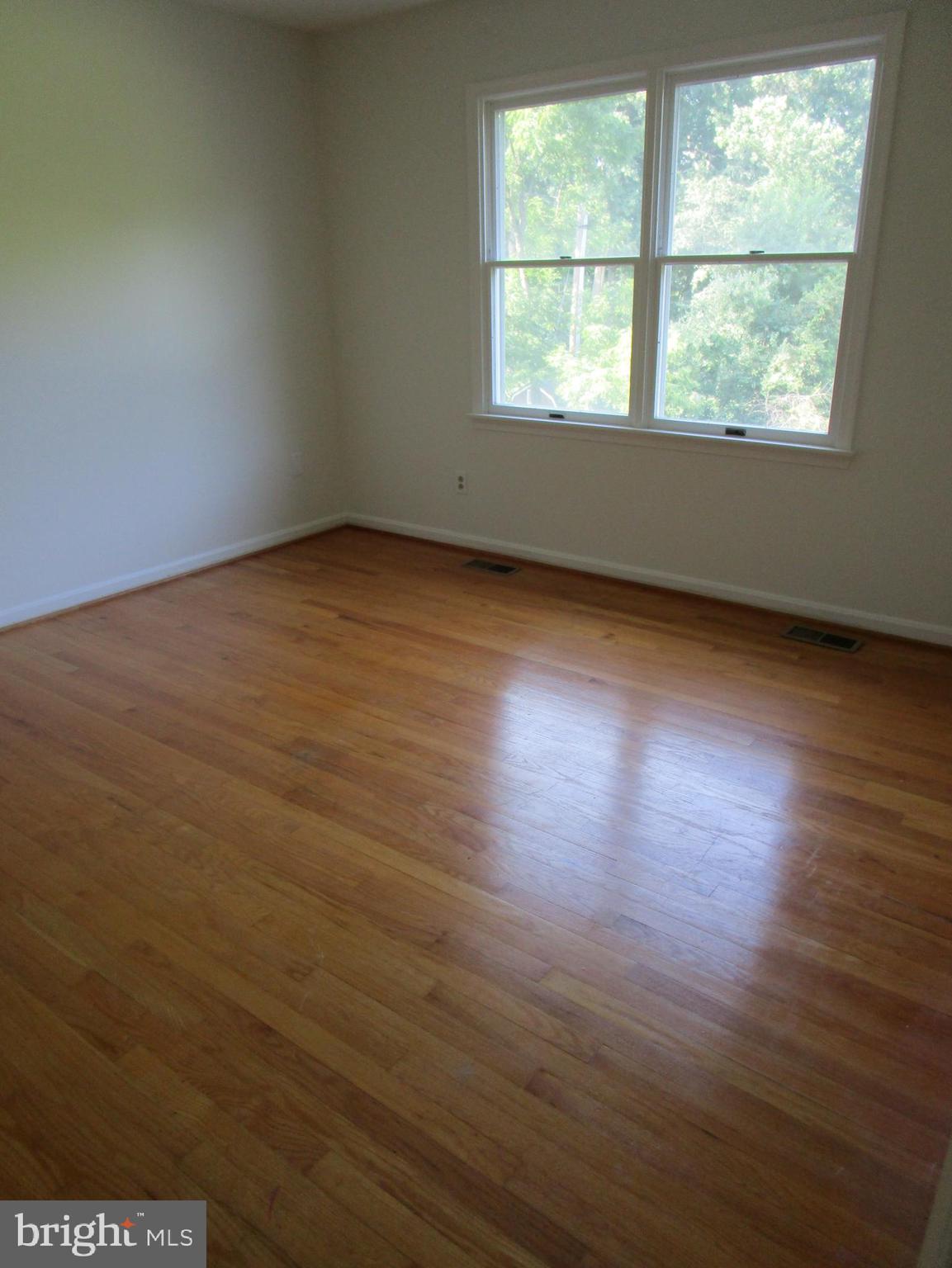 8505 Edenton Road Fulton, MD 20759 - Photo 32 of 38 an empty room with wooden floor and windows