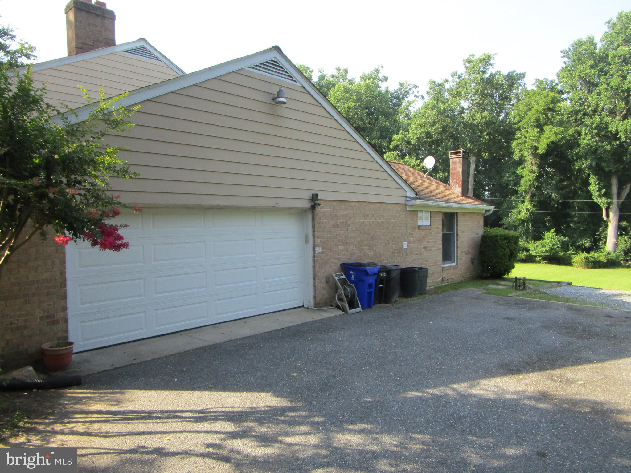 8505 Edenton Road Fulton, MD 20759 - Photo 37 of 38 a view of a house with a yard and garage