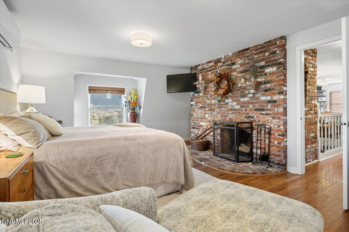 20855 Ames Lane Reno, NV 89521 - Photo 25 of 66 a bed room with a bed and a fireplace
