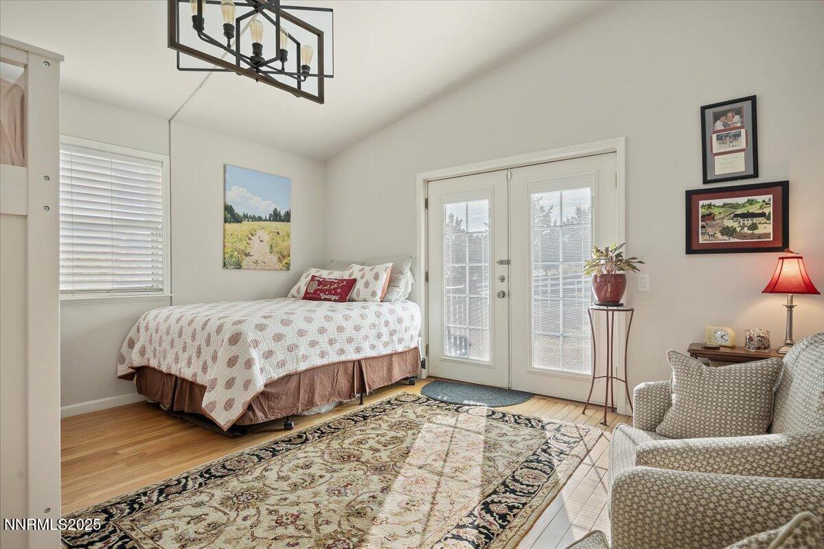 20855 Ames Lane Reno, NV 89521 - Photo 30 of 66 a bedroom with a bed and wooden floor