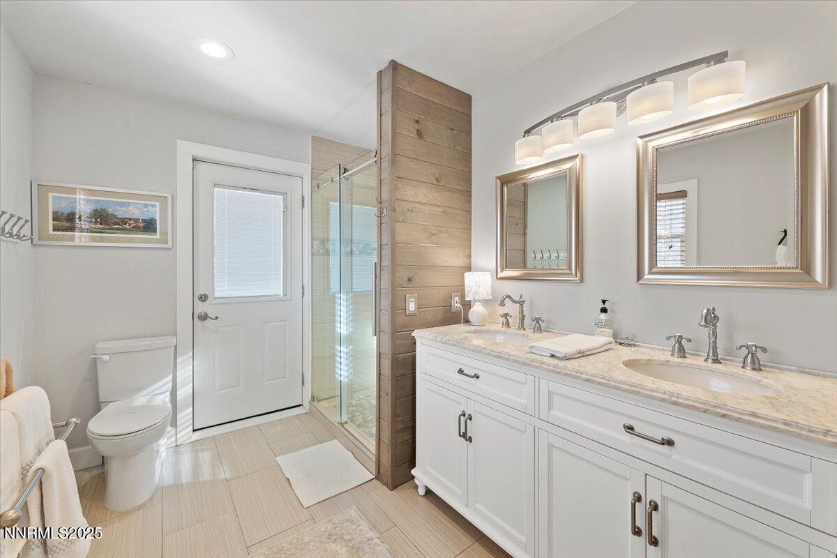 20855 Ames Lane Reno, NV 89521 - Photo 31 of 66 a spacious bathroom with a granite countertop sink mirror and a toilet