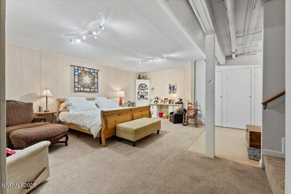 20855 Ames Lane Reno, NV 89521 - Photo 33 of 66 a bed room with furniture and a chandelier