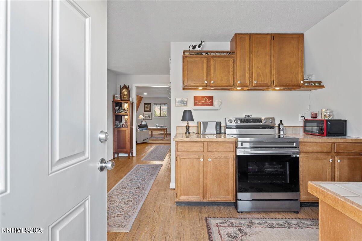 20855 Ames Lane Reno, NV 89521 - Photo 36 of 66 a kitchen with stainless steel appliances granite countertop a stove and a refrigerator
