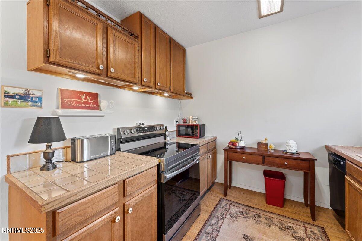 20855 Ames Lane Reno, NV 89521 - Photo 37 of 66 a kitchen with stainless steel appliances granite countertop a stove and a sink
