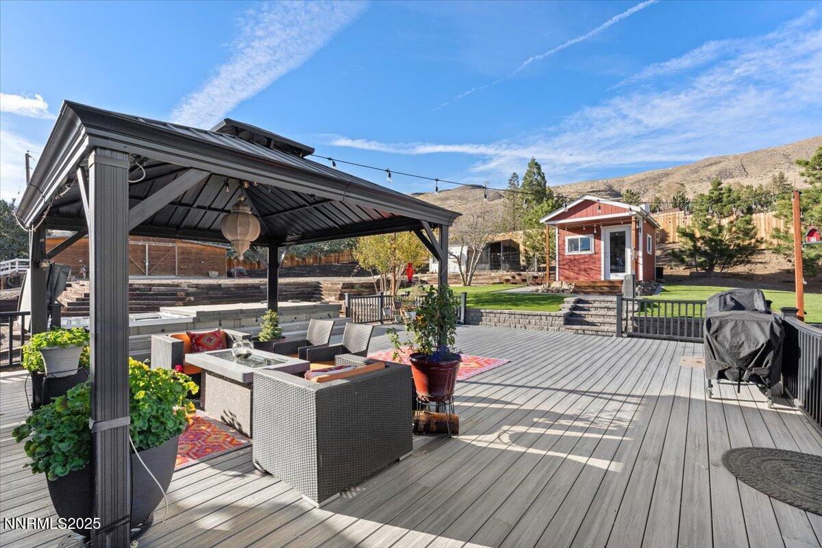 20855 Ames Lane Reno, NV 89521 - Photo 45 of 66 a view of a patio with table and chairs potted plants with wooden floor