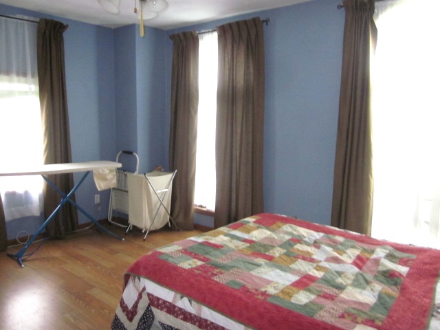 16169 Anderson Road Durand, IL 61024 - Photo 9 of 25 a bedroom with a bed and wooden floor