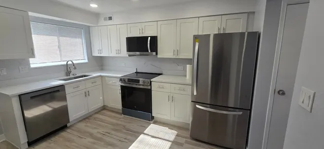 a kitchen with a refrigerator sink and microwave