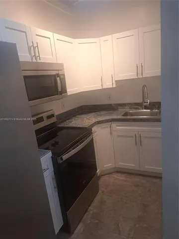 a kitchen with a stove microwave and sink