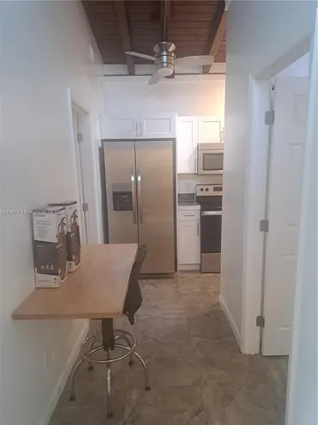 a kitchen with refrigerator cabinets and stainless steel appliances