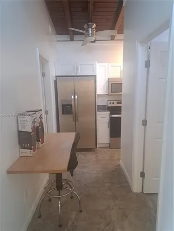 a kitchen with refrigerator cabinets and stainless steel appliances