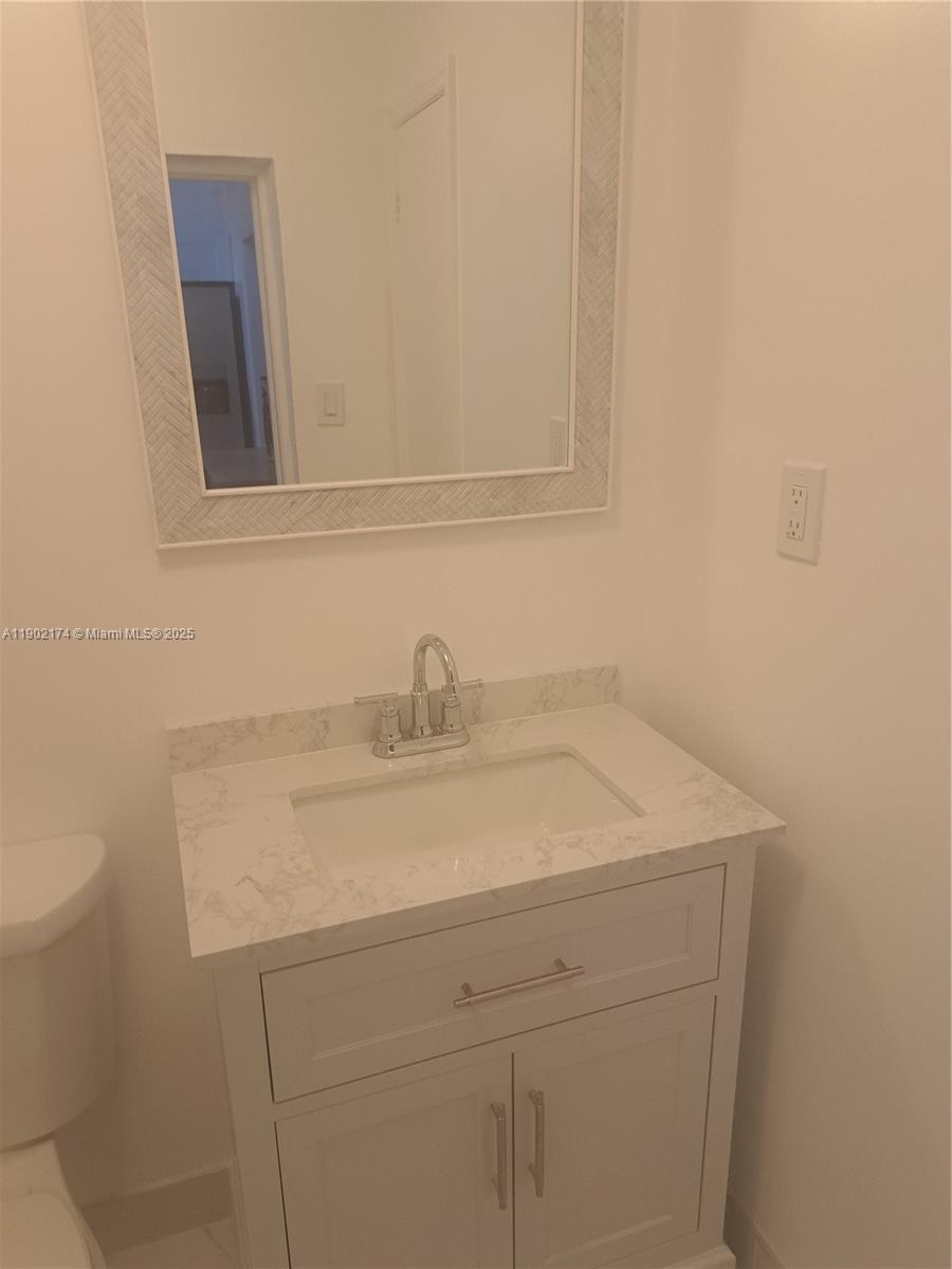 17 Northeast 2nd Road, Unit B Homestead, FL 33030 - Photo 4 of 8 a bathroom with a sink and vanity