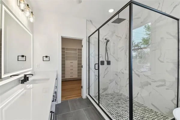 a bathroom with a sink vanity and a mirror