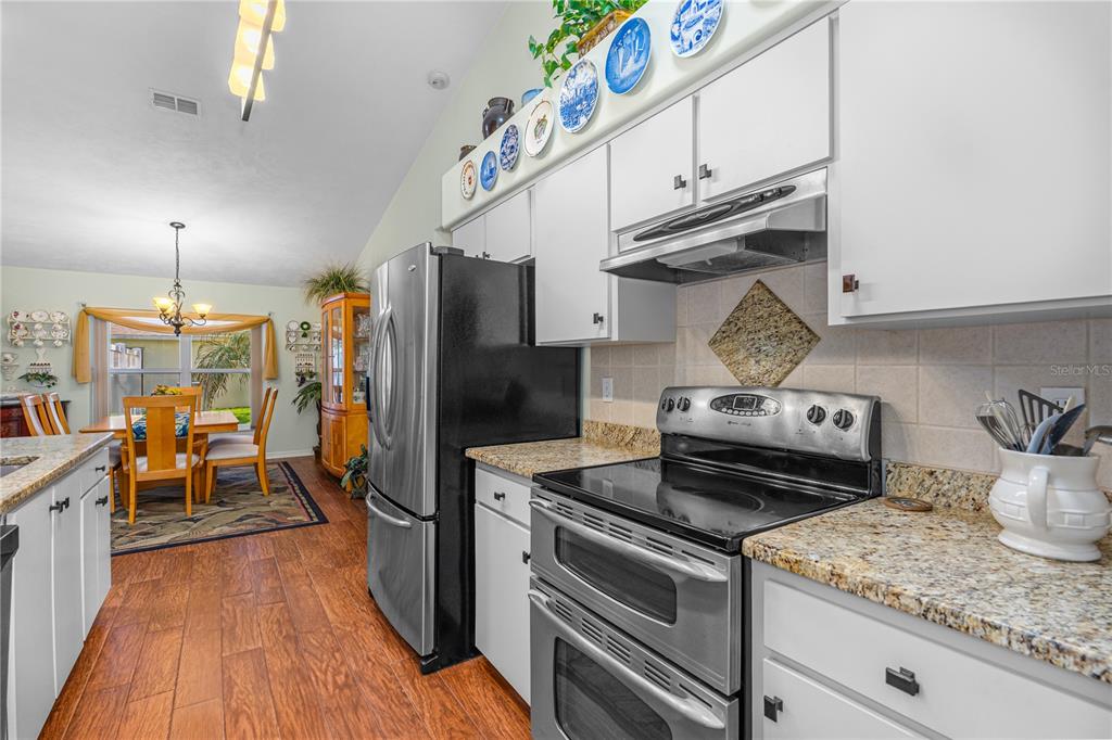 993 Appleview Way Port Orange, FL 32127 - Photo 11 of 46 a kitchen with stainless steel appliances granite countertop a stove and a refrigerator