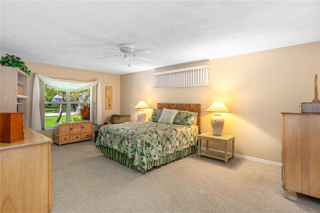 993 Appleview Way Port Orange, FL 32127 - Photo 17 of 46 a bedroom with a bed and large windows