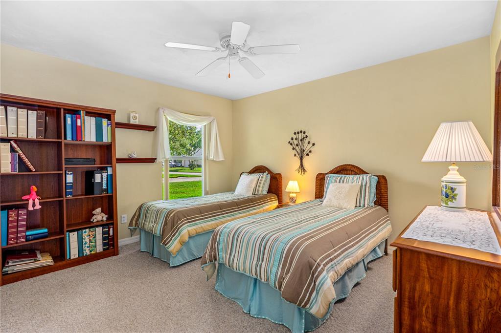 993 Appleview Way Port Orange, FL 32127 - Photo 23 of 46 a bedroom with a bed a dresser and a book shelf