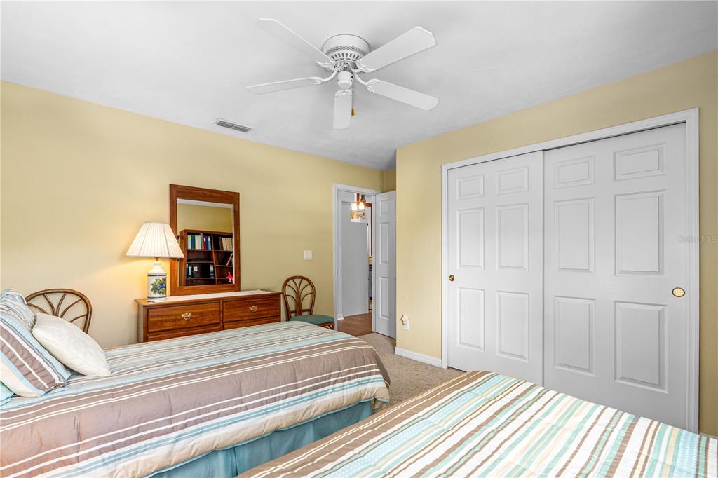 993 Appleview Way Port Orange, FL 32127 - Photo 24 of 46 a bedroom with a large bed and a chandelier fan