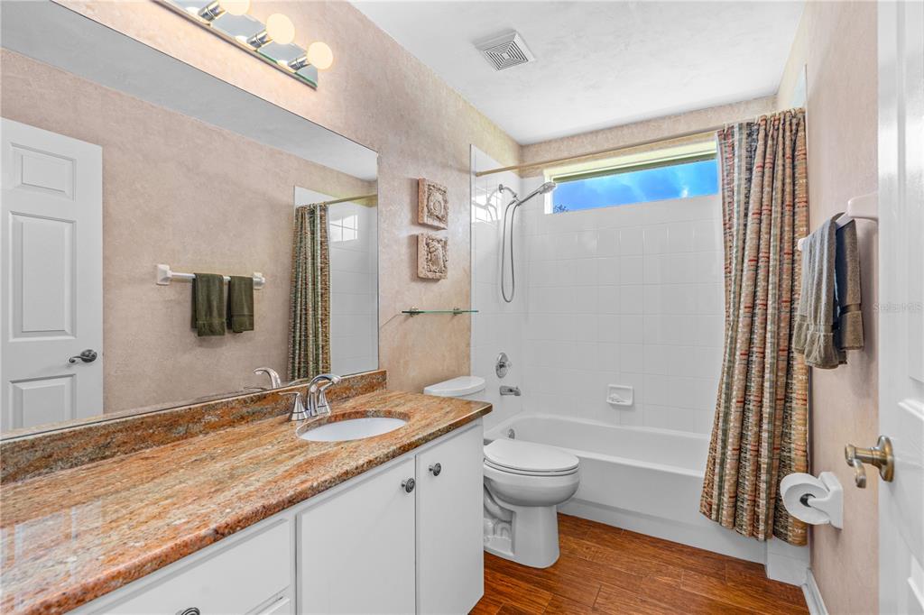 993 Appleview Way Port Orange, FL 32127 - Photo 27 of 46 a bathroom with a granite countertop sink toilet and shower