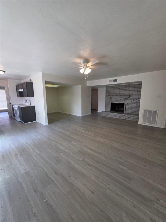 9804 Sophora Circle Dallas, TX 75249 - Photo 2 of 12 a view of a livingroom with an empty space and a fireplace