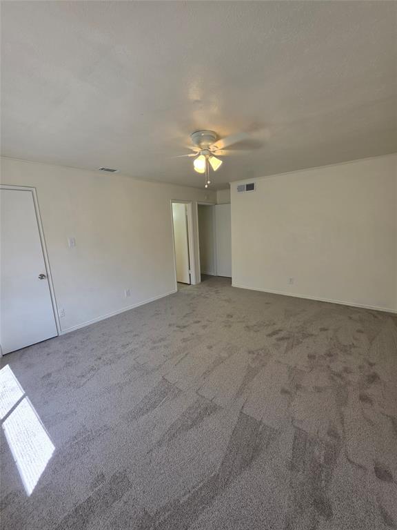 9804 Sophora Circle Dallas, TX 75249 - Photo 5 of 12 an empty room with chandelier fan