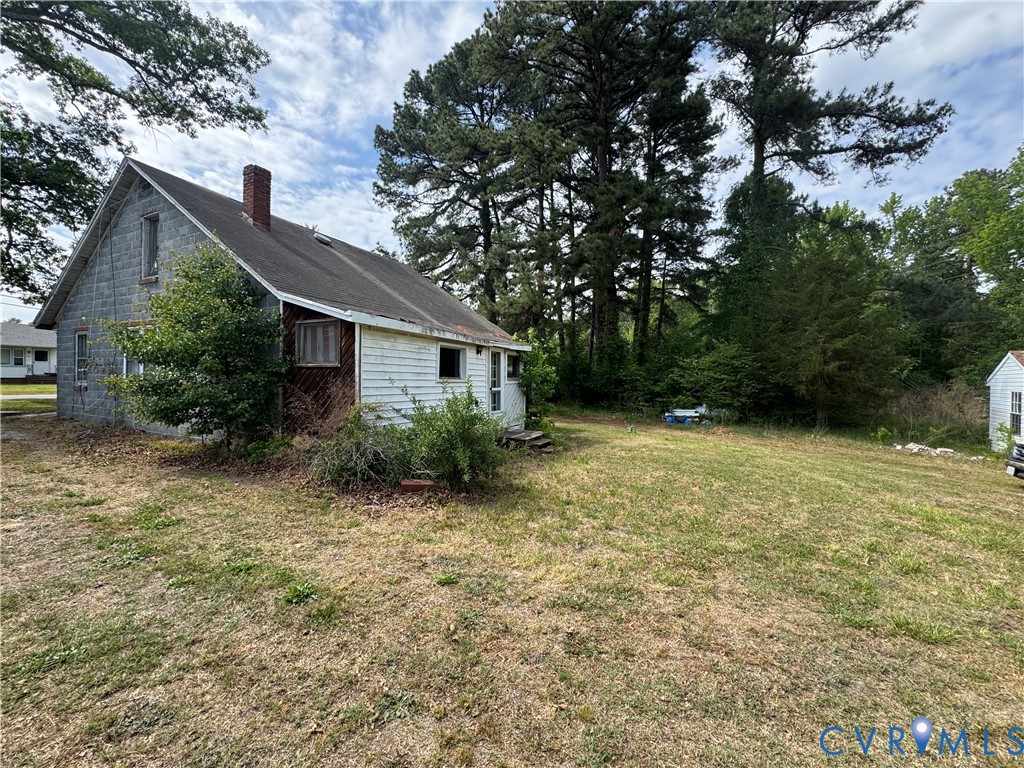 303 Purdy Road Emporia, VA 23847 - Photo 2 of 18 a view of house with backyard and garden