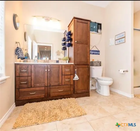 a bedroom with furniture and a chandelier fan