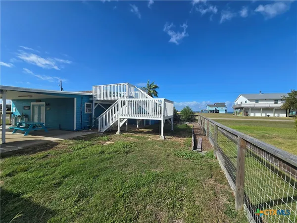 a view of a terrace with a table and chairs