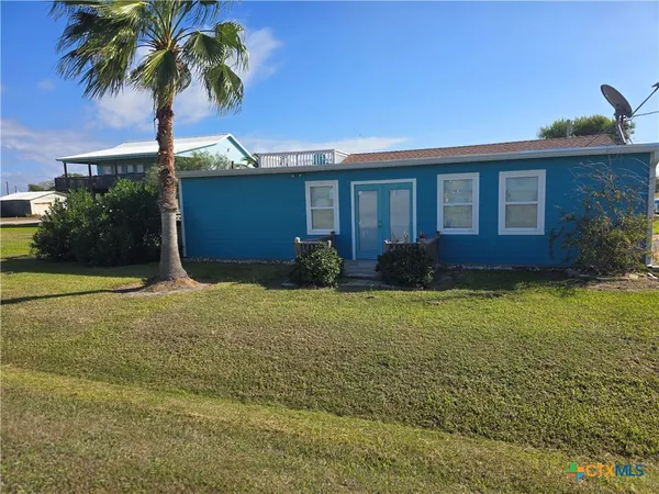 a view of a patio with chairs and a table