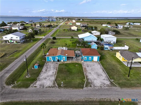 a view of a backyard with table and chairs under an umbrella