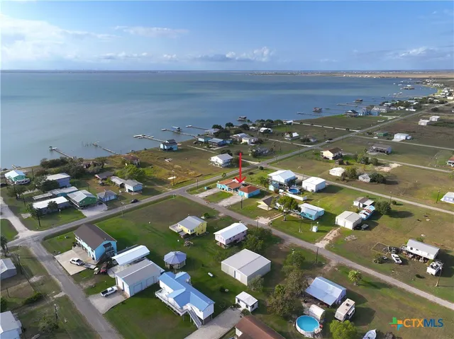 a kitchen with a dining table chairs and refrigerator