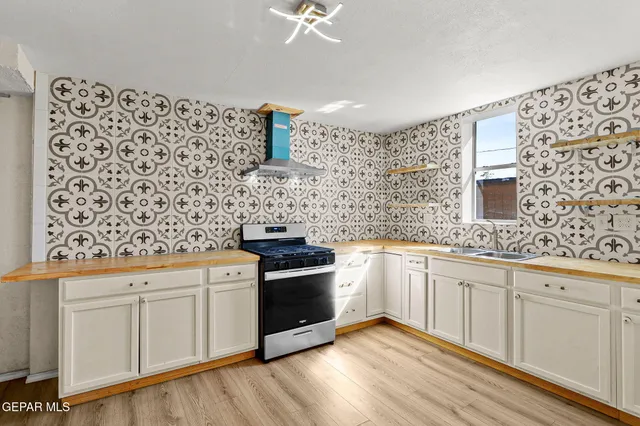 a kitchen with a refrigerator and a stove