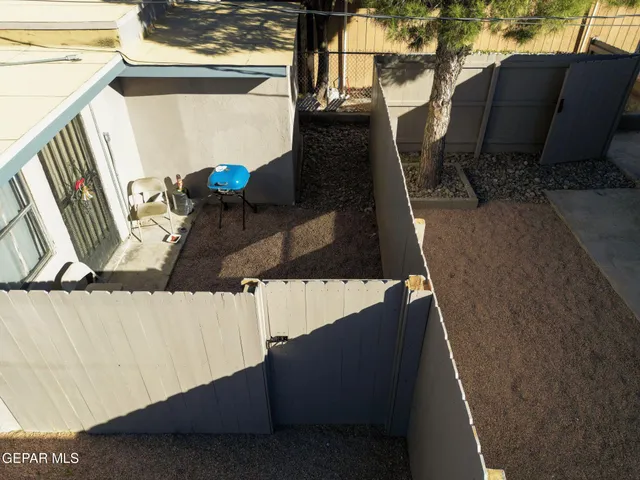 a view of roof deck with wooden floor and seating space