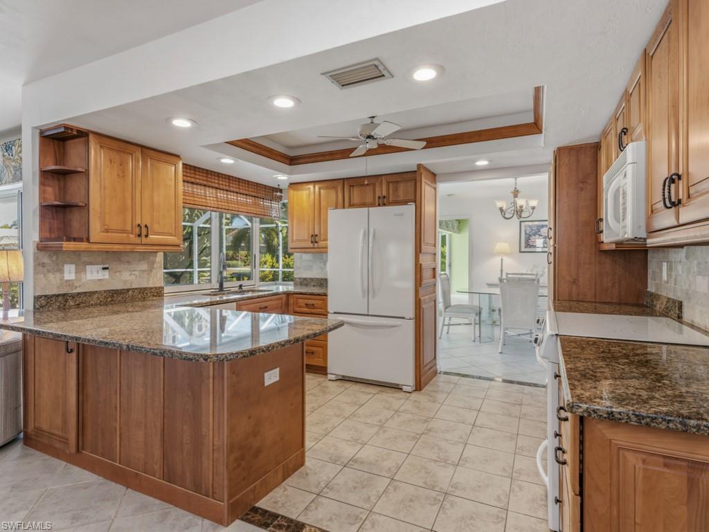 1081 Ruppert Road Marco Island, FL 34145 - Photo 11 of 39 a kitchen with stainless steel appliances granite countertop a refrigerator a sink and a stove