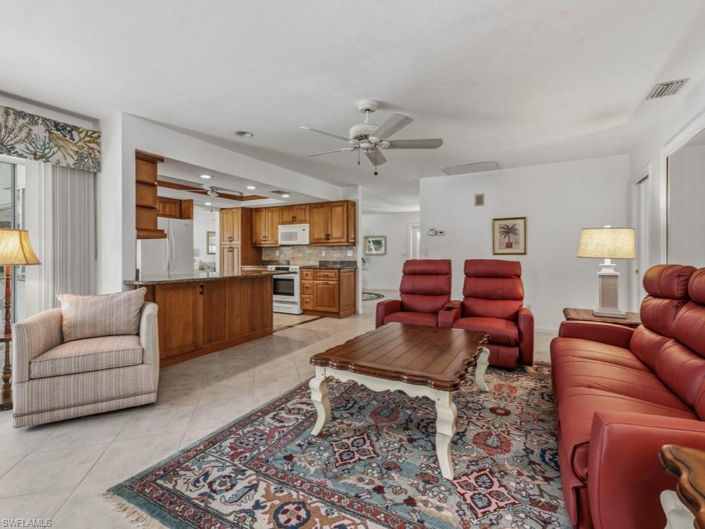 1081 Ruppert Road Marco Island, FL 34145 - Photo 16 of 39 a living room with furniture kitchen view and a chandelier